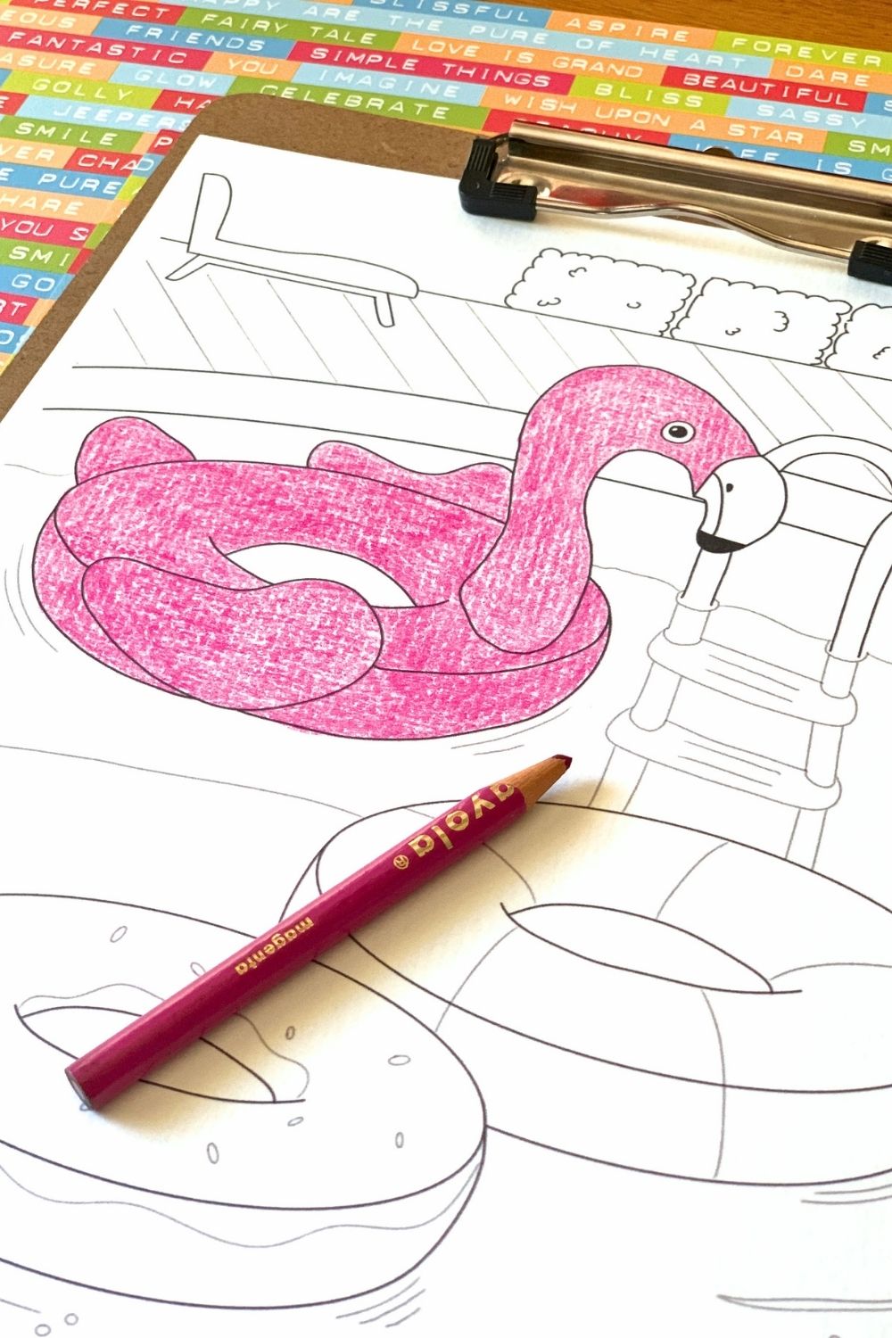 Coloring a flamingo float picture with a pink pencil.