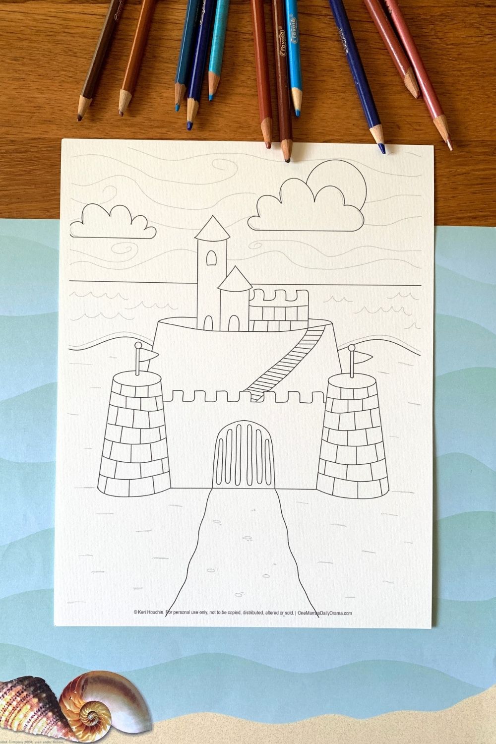 Sandcastle coloring page with turrets on 2 corners, a center gate, and a staircase that leads to a platform of small buildings.