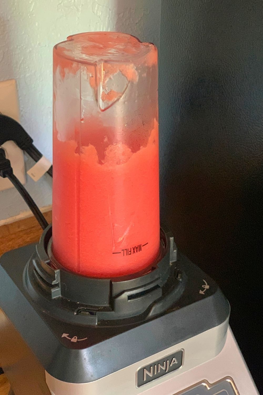 A cup of blended fruit and ice.