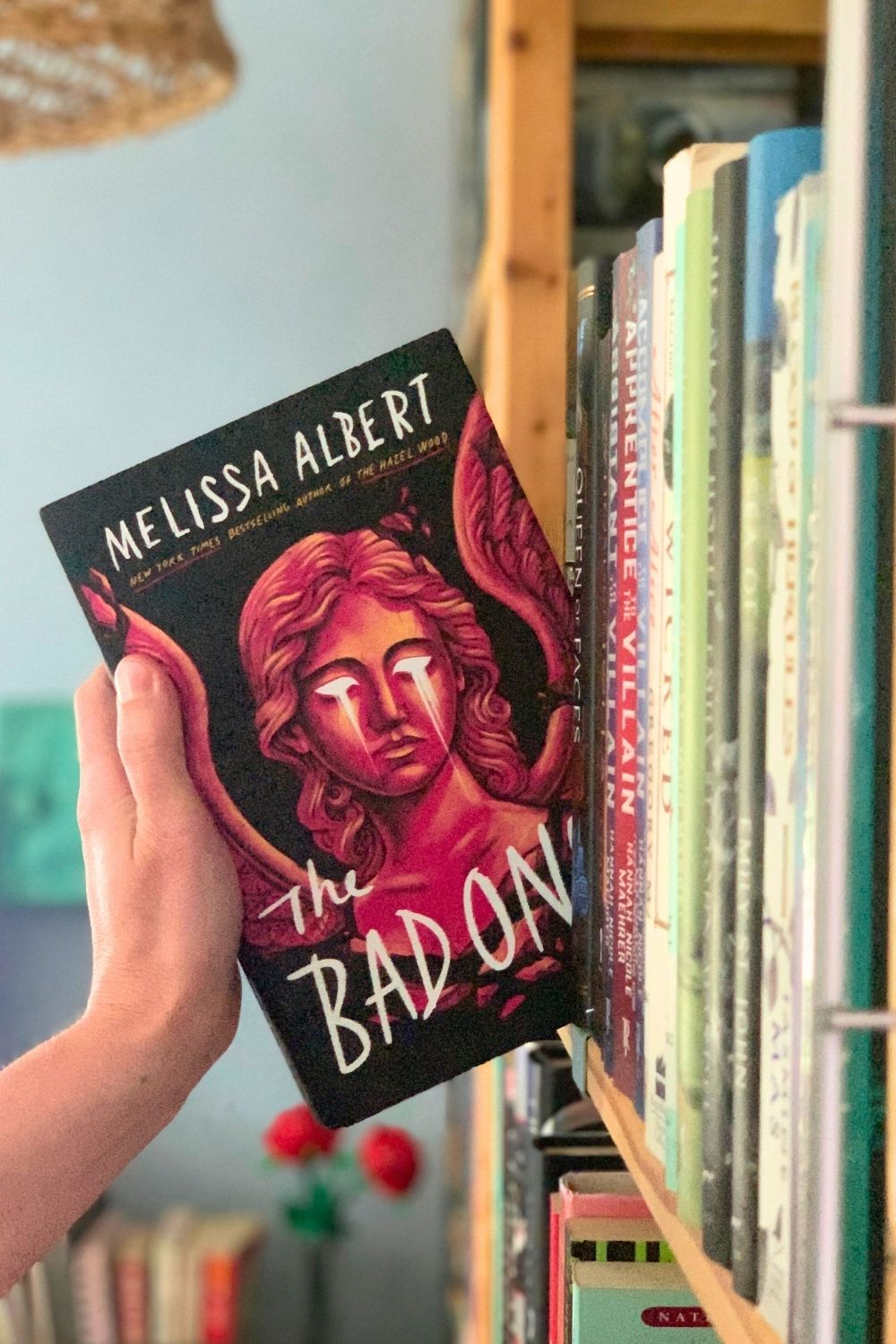 A shelf with a hardcover book The Bad Ones by Melissa Albert.