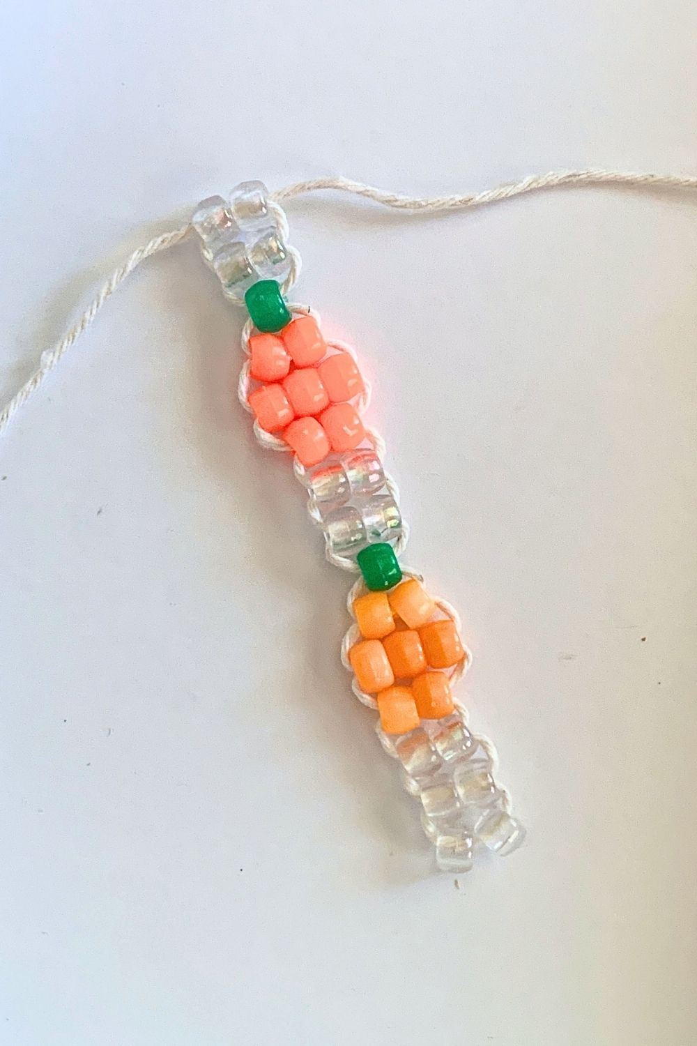 Continuing a bead bracelet pattern with a second pumpkin and 2 pair of clear beads.