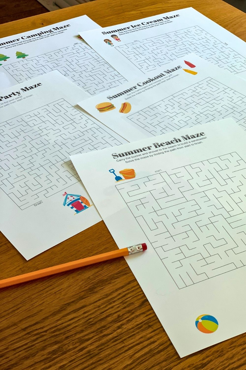 Printed summer mazes and a pencil.