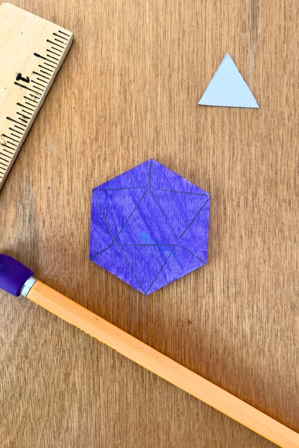 A purple hexagon with a triangle in the center and lines extending to all.