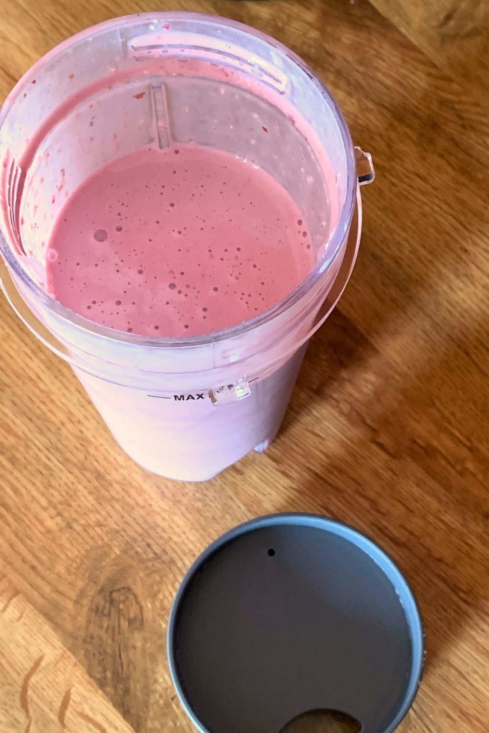 Closeup of a blended smoothie with a creamy texture and naturally vibrant pink color.