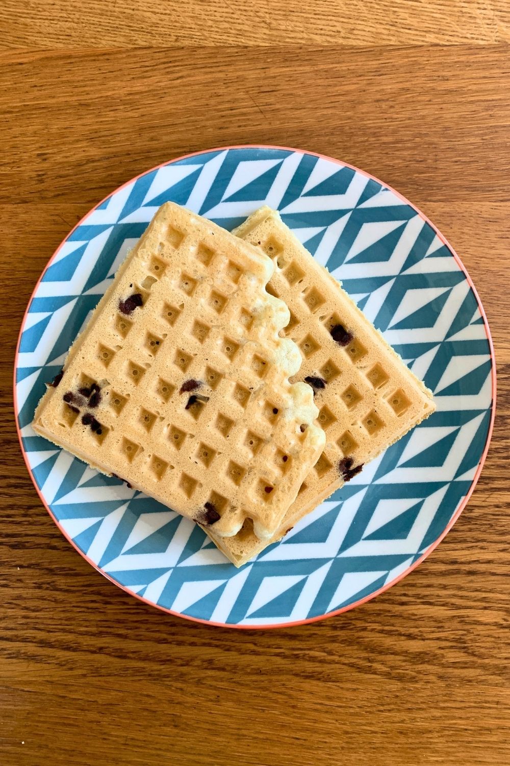 Two waffles on a plate.
