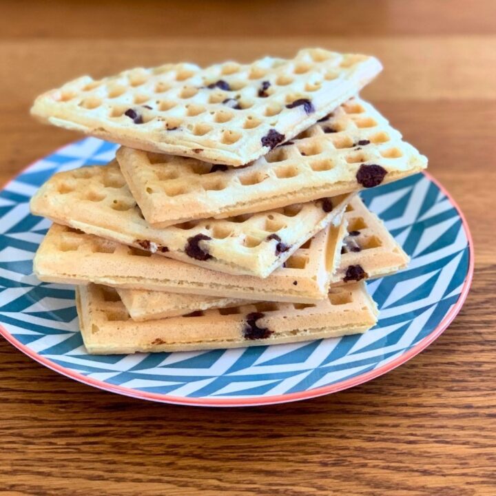 A stack of chocolate orange waffles on a plate.