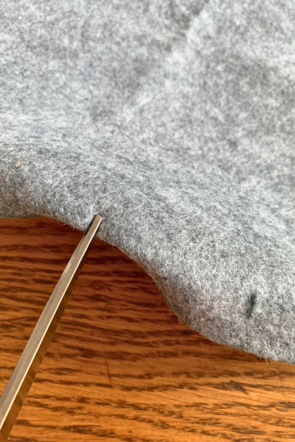 Snipping small slits in folded felt.