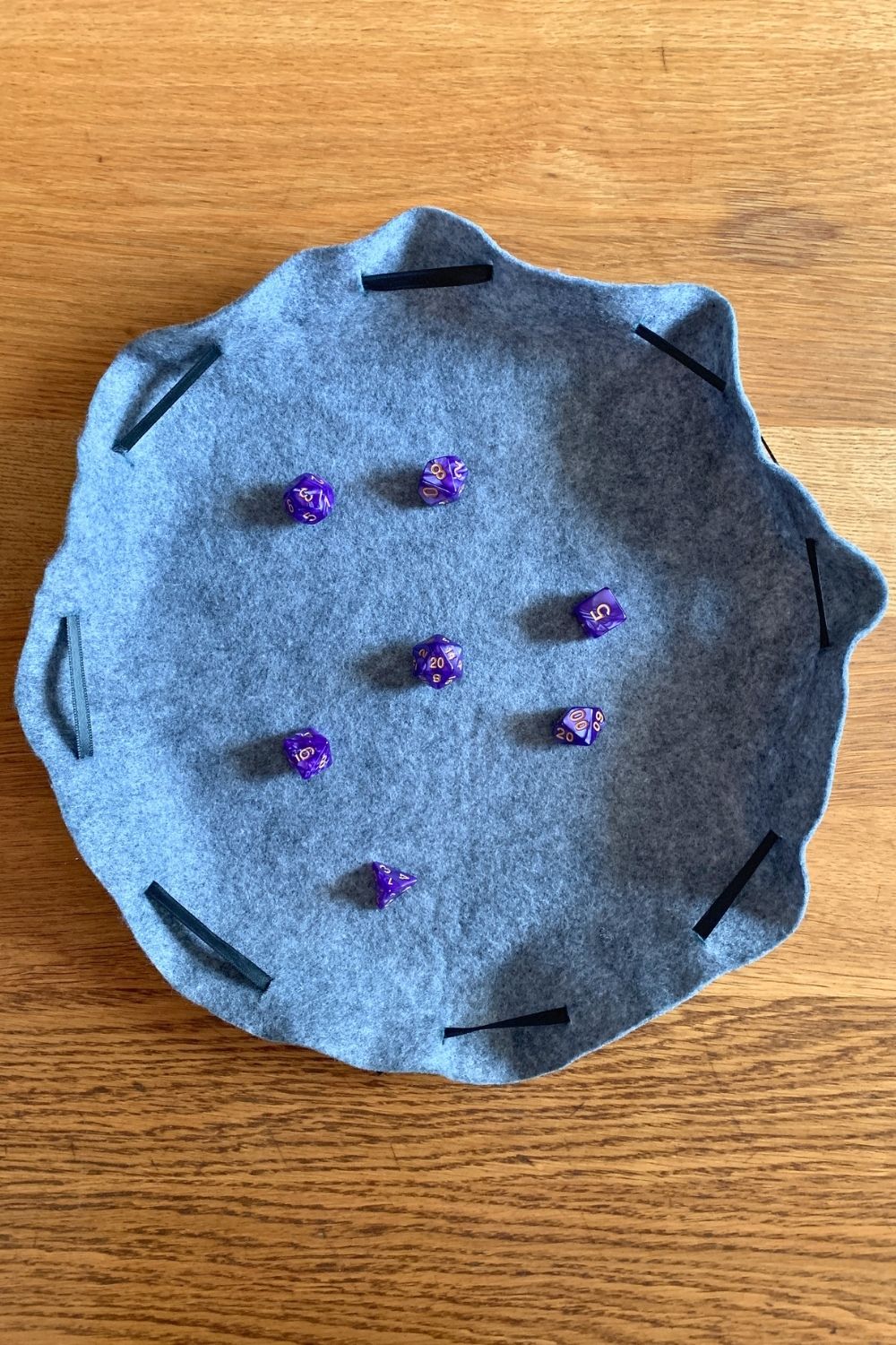 Rolling several dice on a no-sew bag pulled open flat.