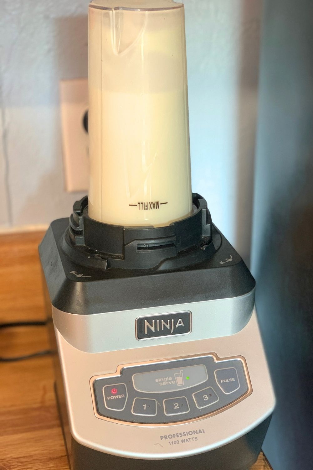 A pale yellow-green mixture in a blender cup.