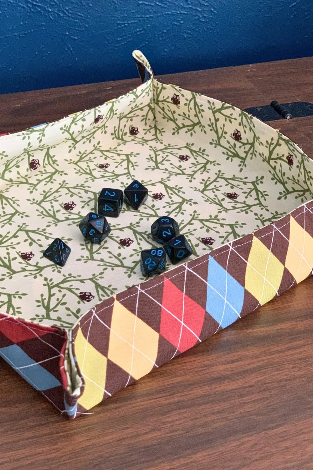 A handful of dice scattered in the center of a handmade fabric tray.