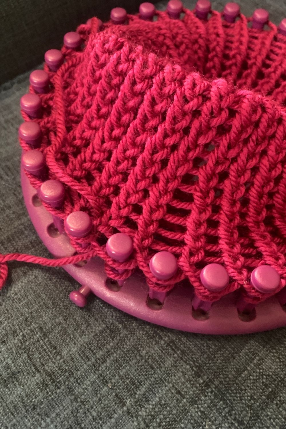Folding a knitted piece in half to loop back on itself.