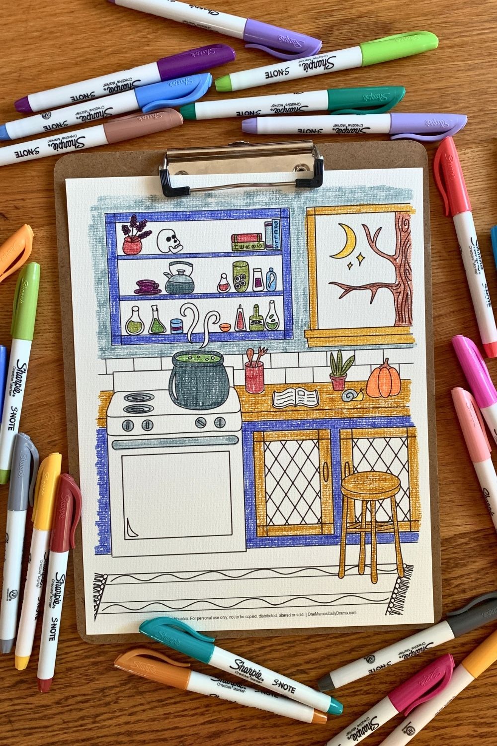 Two dozen Sharpie markers surrounding the coloring sheet on a clipboard.