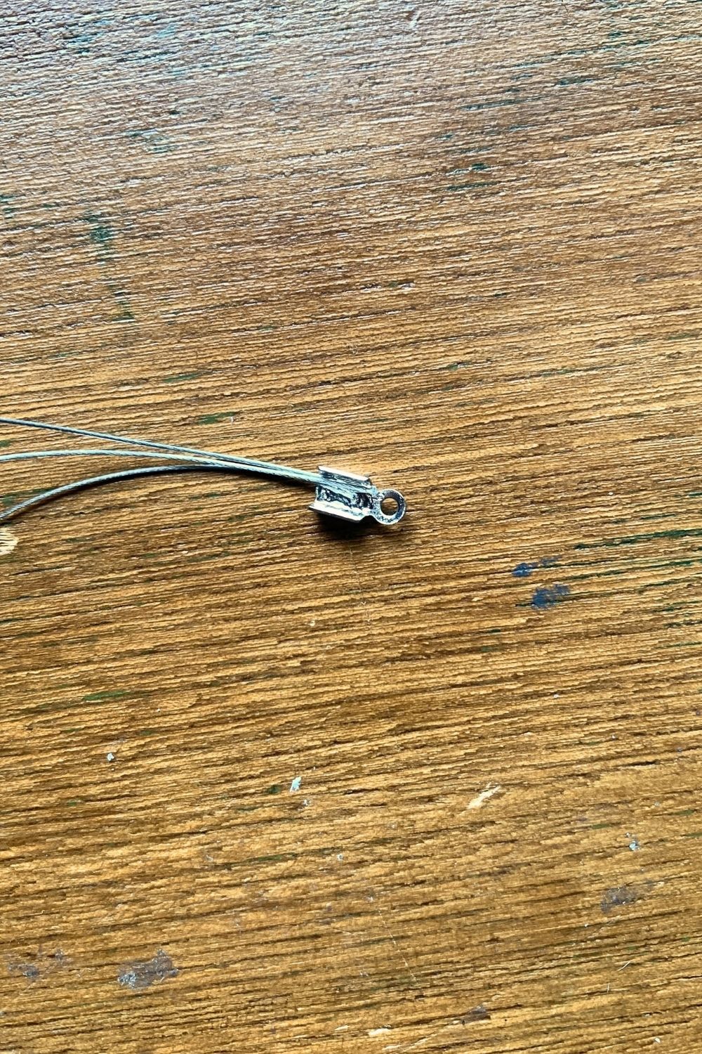 Three strands of jewelry wire inside an open end crimp piece.