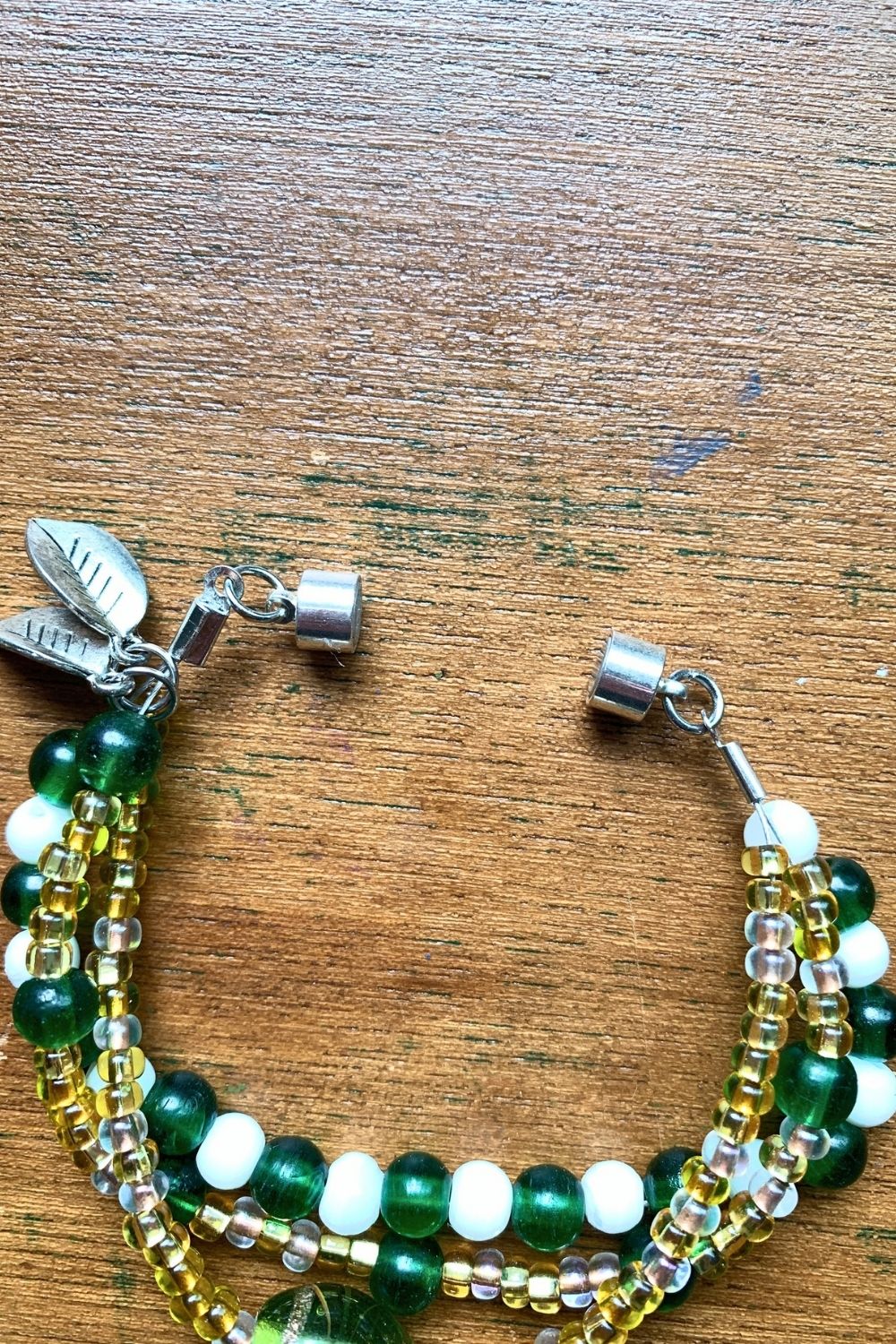 A 3-strand bead bracelet with a magnetic closure.