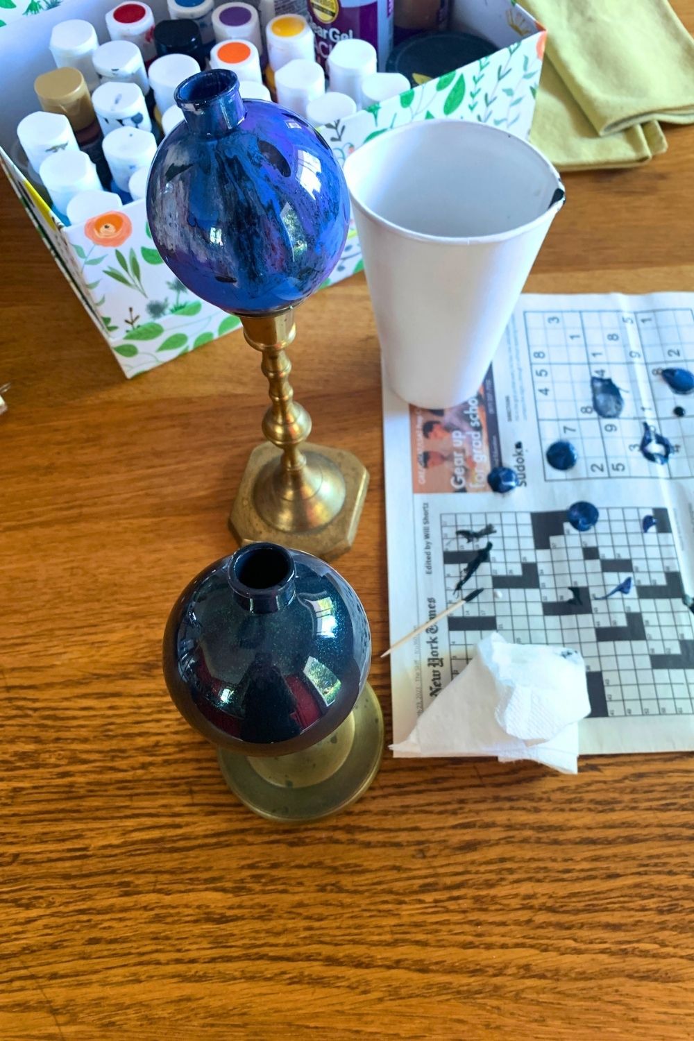 Ball ornaments balanced stem-up to dry the paint inside.