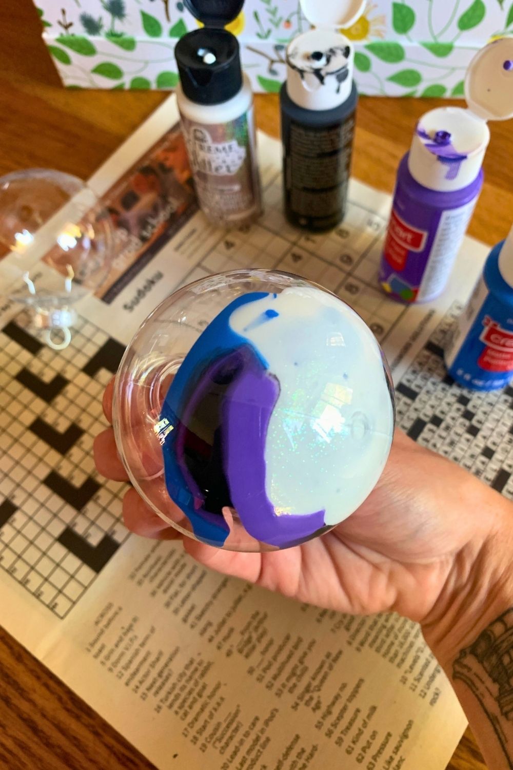 Swirling glitter and paint in a clear ball ornament.