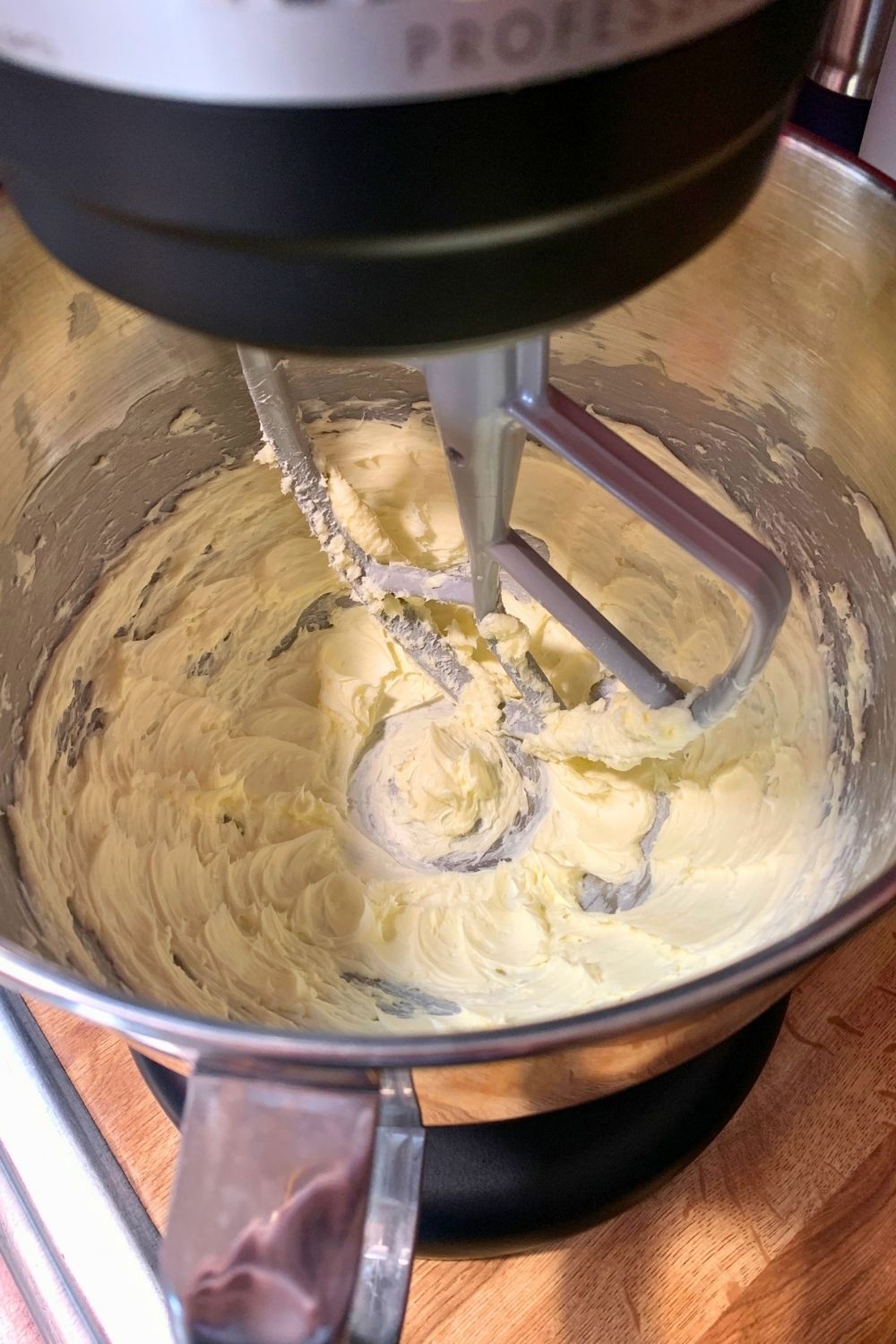 Pale butter in the bowl of a stand mixer whipped smooth with the paddle attachment.