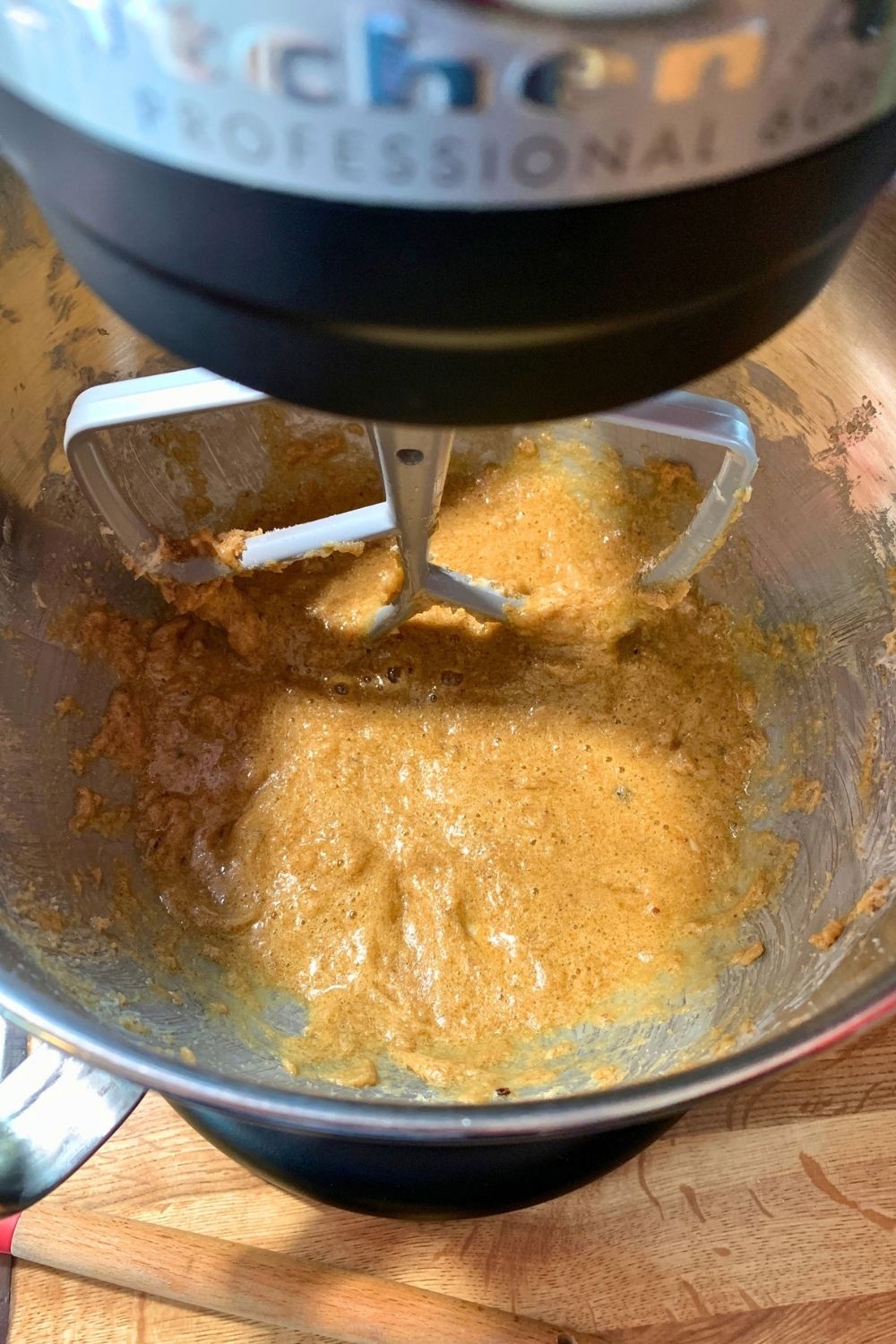 Runny cookie dough batter with egg in the bowl of a stand mixer.