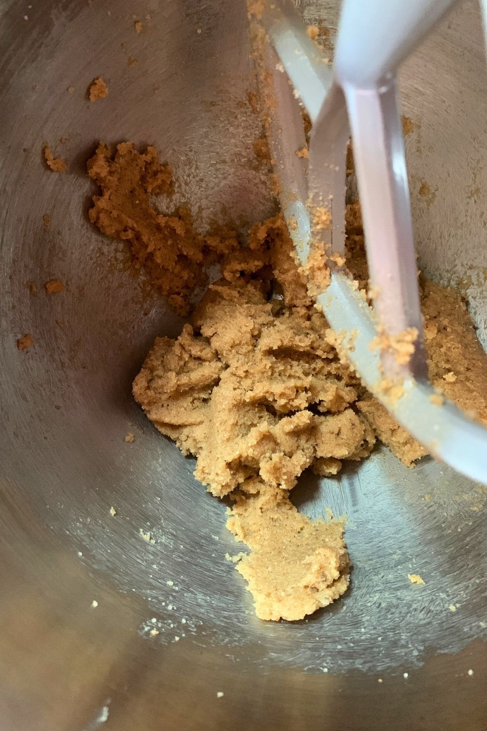 Butter and sugar creamed together in a mixing bowl.