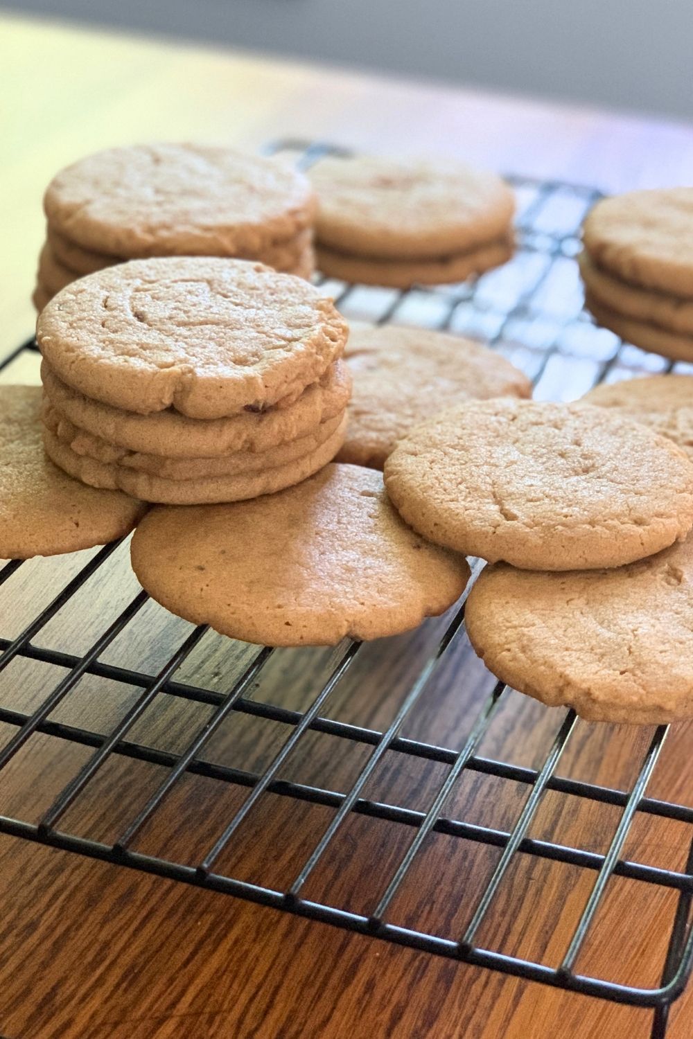 Stacks of peanut butter cookies on a cooling rack.