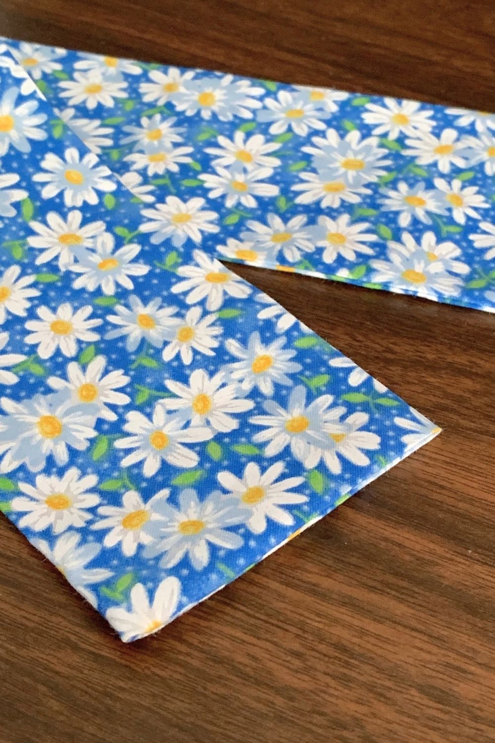 Closeup on the end of a fabric tube with the end turned in and ironed flat.