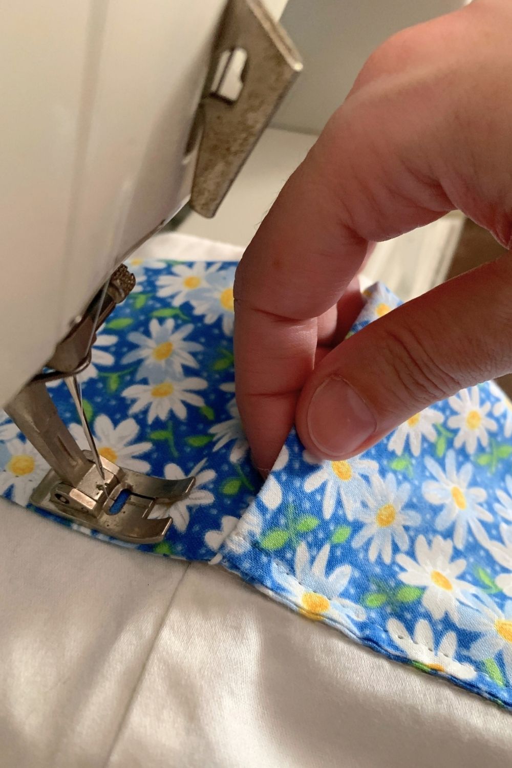 Tucking one end of the daisy fabric inside the other end.