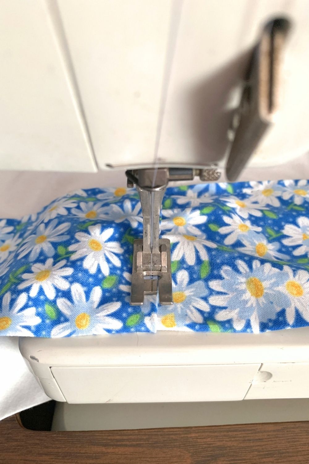 Sewing the end of the daisy fabric closed.